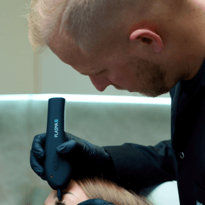 Dermatologist MUDr. Martin Bortlík performing an eyelid treatment on a young patient using a plasma pen.
